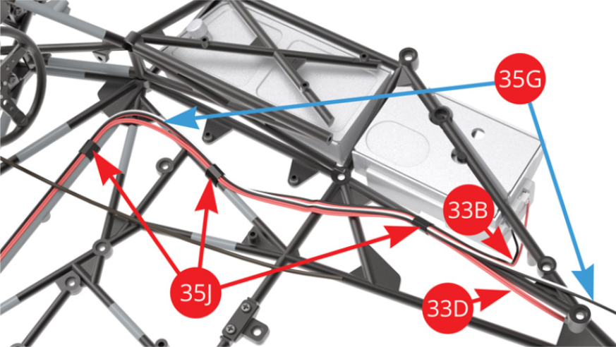 Attach the right fuel tank cable / black-red (33B), the switch cable / red (33D) and the longer (blue arrow) tail light LED cable / black-white (35G) to the right side of the frame with two more pieces of tape (35J).