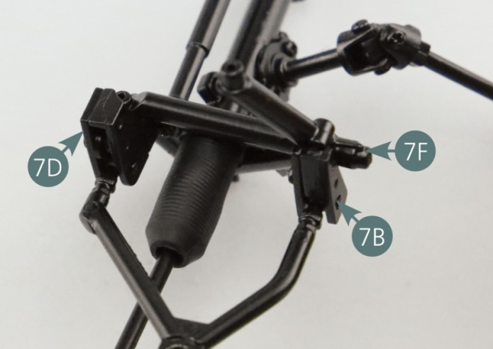 Position the brackets (7B & 7D) carrying the upper left suspension arm (7A) onto the left side frame (7F) and secure them with two AM screws.