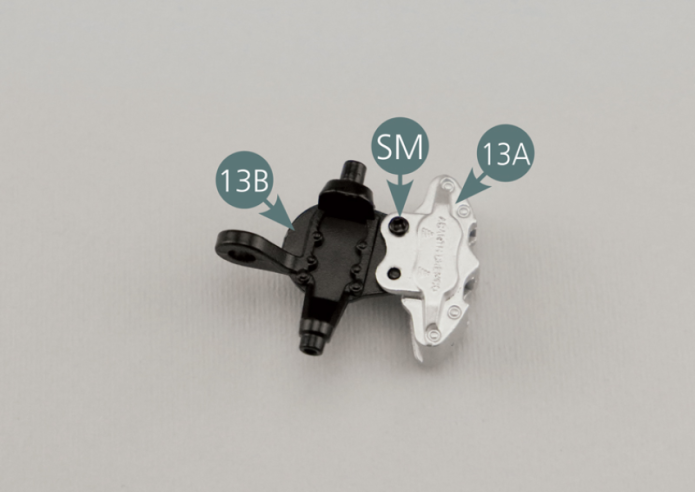 Position the left front brake calliper (13A) onto the left front pivot (13B) and secure it with an SM screw.
