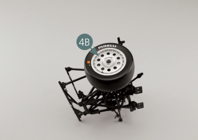Position the hub of the outer wheel rim (4B) on the left front pivot pin (13B) and gently turn the wheel to engage it onto the brake disc (4E). Then secure the wheel with a VM screw after passing it through the washer (13H).