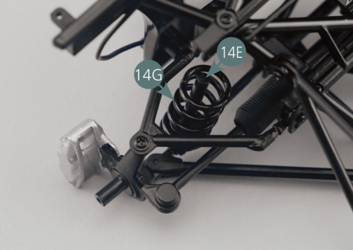 Place the suspension spring (14G) and suspension shock absorber (14F) on the suspension piston pin (14E). Position the head of the suspension shock absorber (14F) on the chassis top frame (11A) and secure it with a GM screw.