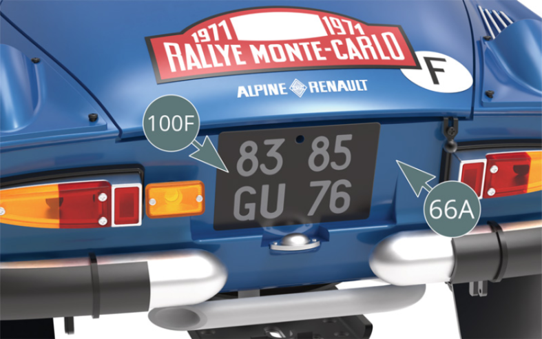Apply the rear license plate sticker (100F) from car #9 to the rear panel of the body (66A), making sure to correctly align the openings in the plate and rear panel.
