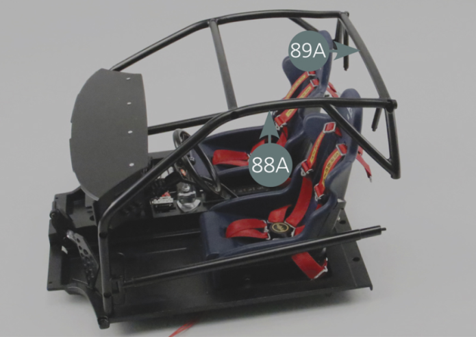 Turn the assembly over and secure the right cage of the roll bar (89B) on the right floor panel (67B) with an AM screw from below.