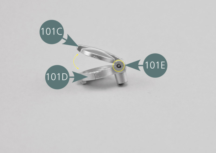 Position the fuel cap (101C) on the cap support (101D) and check the alignment of the openings. Detach a plug (101E) from its sprue with a tweezer. Insert the plug (101E) - using tweezers - into the opening in the cap (101C) and the support (101D) as shown. Check that the cap opens correctly.