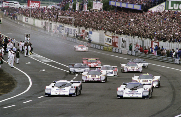 Un’immagine catturata qualche istante dopo la partenza della 24 Ore di Le Mans del 1987, dominata dalla Porsche che giunge prima e seconda con due 962C (in testa al gruppo nella foto). In quell’edizione la 961 si ritira per incidente dopo una bella rimonta. © IXO Collections SAS - Tous droits réservés. 