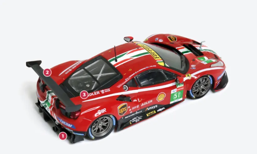 1. On the 488 GTE Evo, the extractors mounted at the rear are larger and more prominent.2. The design of the carbon spoiler has been slightly modified, while retaining its overall shape.3. The V8 twin-turbo engine has been thoroughly redesigned compared to the standard unit. The displacement has been increased from 3,902 to 3,996 cc. Power, limited by regulations introducing a ‘balance of performance’, has been reduced from 670 hp to around 600 hp.© IXO Collections SAS - Tous droits réservés.