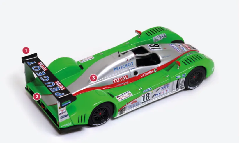 1. For the 24 Hours of Le Mans, the C60 is equipped with a higher rear spoiler.2. The Courage C60 features push-rod suspension and an aluminium and carbon fibre body.3. The engine supplied by Peugeot and derived from the production V6 60° 3-litre ES9 was developed at Magny-Cours by Sodemo, increasing the displacement to 3.2 litres and equipping it with two turbochargers and an in-house developed injection system.© IXO Collections SAS - Tous droits réservés.