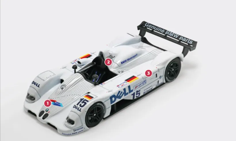 1. Unlike the V12 LM from 1998, the cooling air on the LMR is taken from the top of the bodywork rather than from below. This explains the lowered front end and the open air intakes in the nose and wings.2. Whereas previously it covered the entire passenger compartment, now the anti-rollover safety structure has been moved to the right behind the driver's seat.3. The weight of the V12 LMR is less than 900 kg, the minimum required by the regulations, allowing BMW to position the ballast to optimise weight distribution.© IXO Collections SAS - Tous droits réservés.