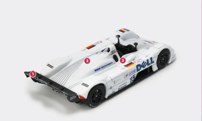 1. As usual, a simplified rear wing is used for Le Mans, generating less aerodynamic downforce.2. The engine is supplied with air via a single periscope intake on the right side.3. The naturally aspirated 6-litre S70/3 V12 engine, an upgrade of the unit fitted to the McLaren F1 GTR, develops just under 600 bhp with the regulation flange on the intake. © IXO Collections SAS - Tous droits réservés.
