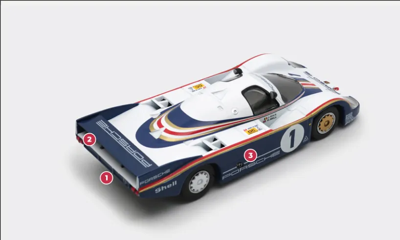 1. The 956 has a flat underbody, as required by regulations, and a barely visible extractor. But its aerodynamics are so carefully designed that it generates three times more downforce than the 917.2. The specific bodywork adopted for races such as Le Mans is of the LH (‘long tail’) type. It features a lower, less sloped spoiler for improved top speed and fuel economy.3. To avoid interfering with the aerodynamics of the rear and to avoid unnecessarily long tubing, the exhaust outlets are located at the sides.© IXO Collections SAS - Tous droits réservés. 