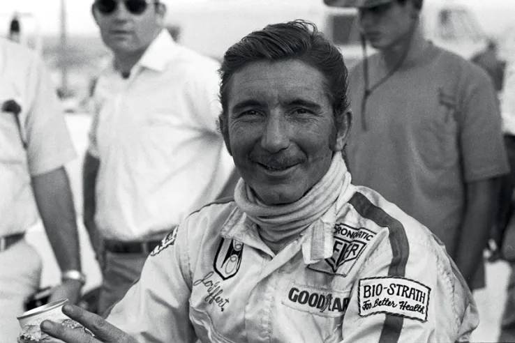 Das Foto zeigt einen lächelnden Jo Siffert auf der Rennstrecke in Texas während der letzten Runde der Can-Am-Saison 1969, wobei er sowohl im Rennen als auch in der Gesamtwertung den vierten Platz belegte.© IXO Collections SAS - Tous droits réservés.